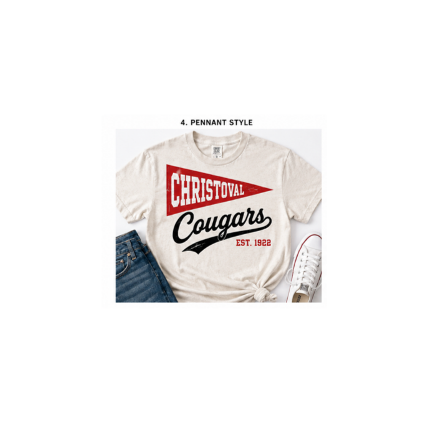 A white-colored t-shirt styled in a flat lay with blue jeans and white sneakers. The shirt features a red pennant graphic with the text 'CHRISTOVAL' and black script text reading 'Cougars' and 'EST.