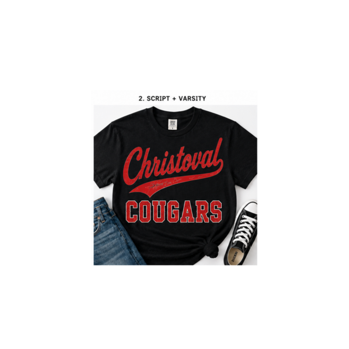 A black short-sleeve T-shirt with a red 'Christoval COUGARS' varsity-style graphic, shown in a styled flat-lay with blue jeans and a black sneaker on a white background. Small text above reads '2.